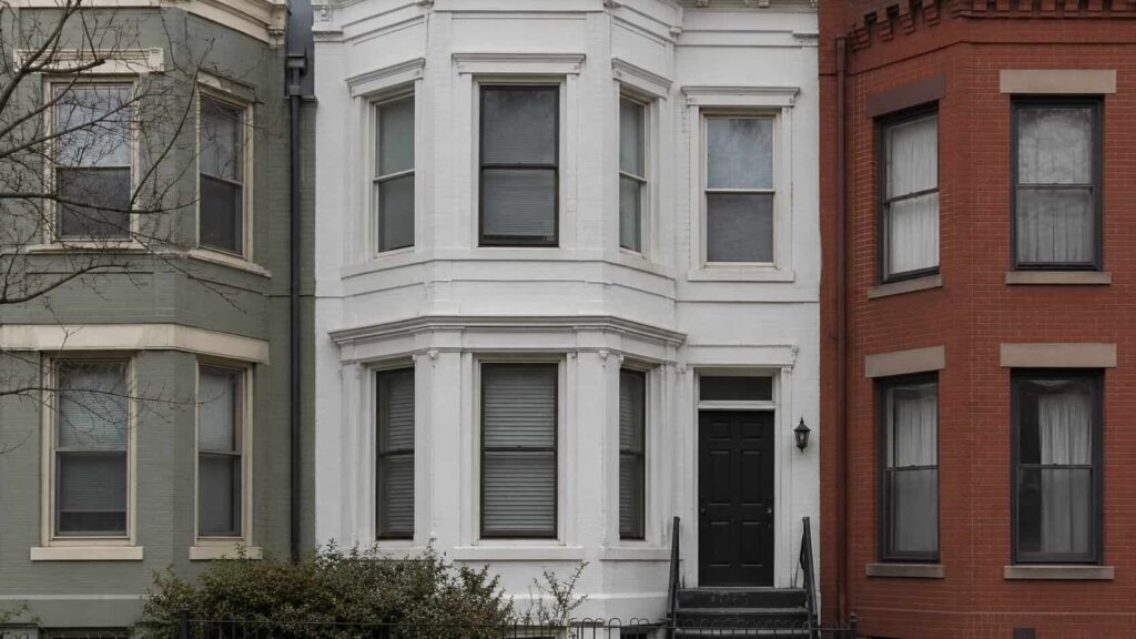 Washington DC rowhouse facade with bay windows and a ground-floor entrance