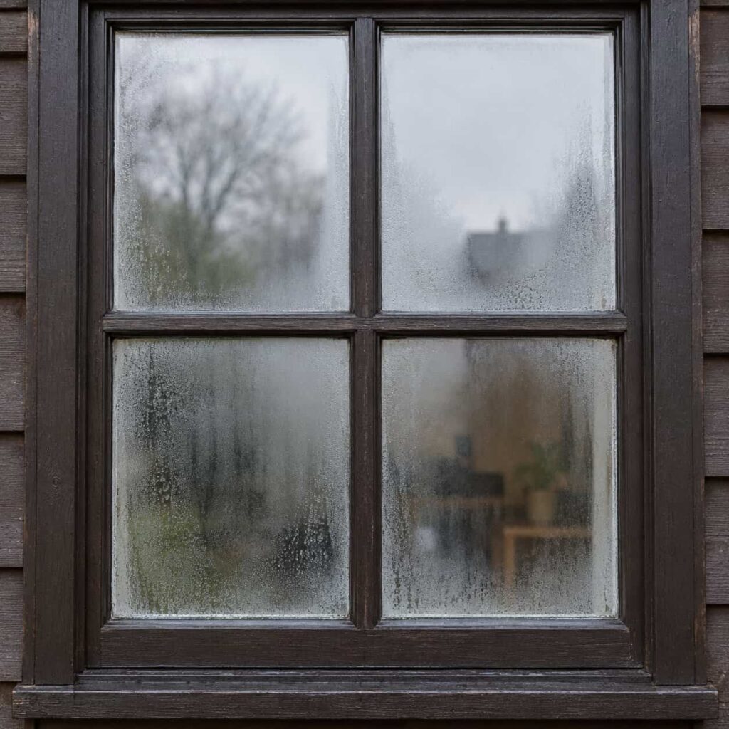 Double-pane window with haze and condensation trapped between the panes