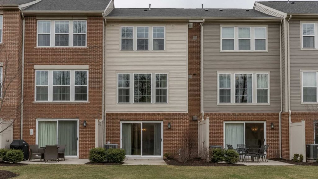 Row of townhouses with double-pane windows and patio doors
